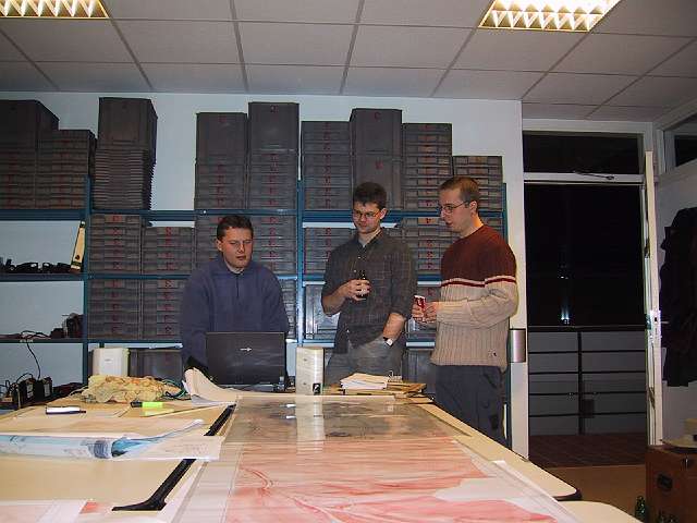 My fellow students probably playing some <i>fifa soccer</i>. The gray plastic cases in the back are used by the archeologists to store, order and catalog their findings.