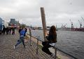 party-people challenging people passing by: who can throw a rotten lemon farther into the Elbe?